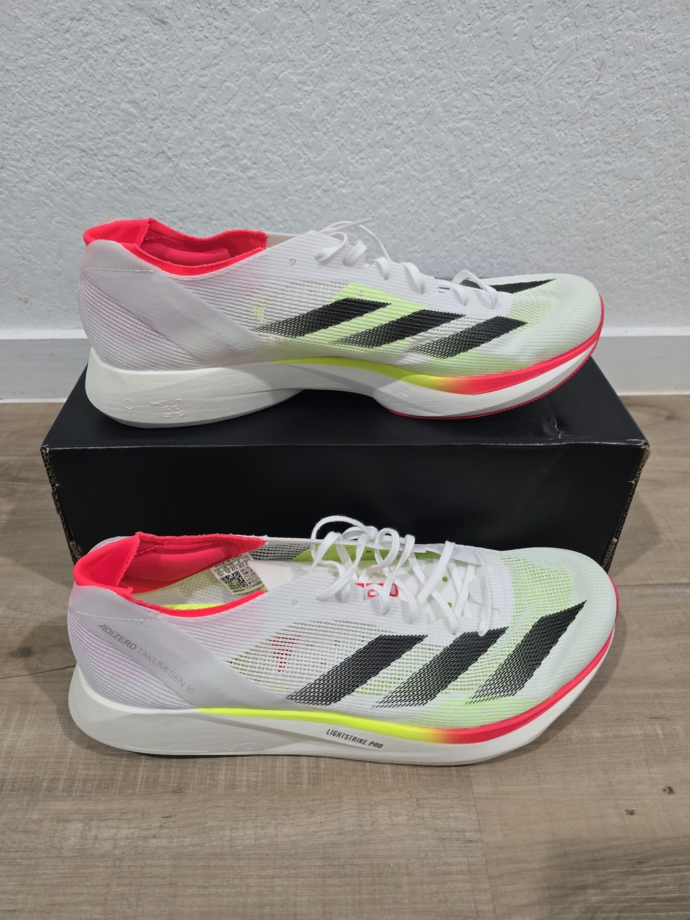 Adizero Racing Shoes in White with Neon Pink Accents